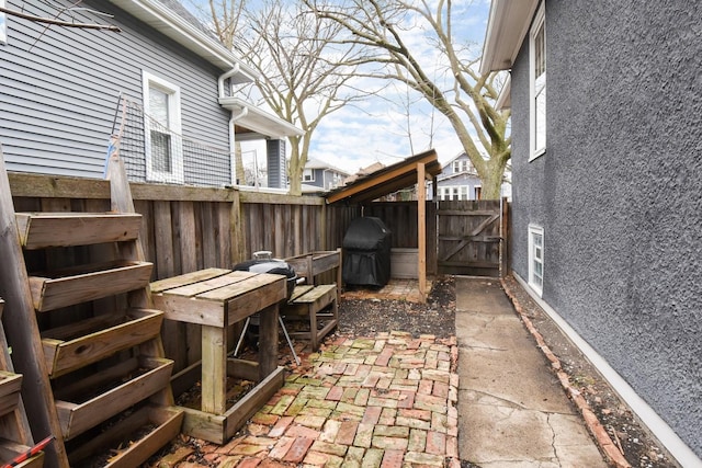 view of patio / terrace featuring a gate, fence, and grilling area