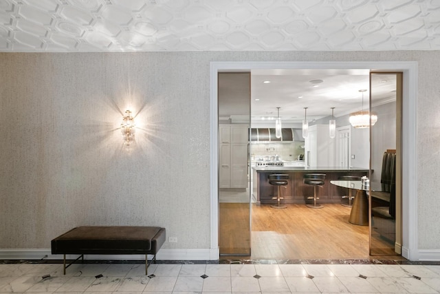 living room with baseboards, light tile patterned floors, and inlaid floor details