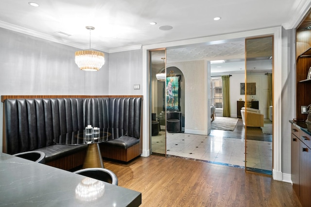 bedroom featuring crown molding, a chandelier, and wood finished floors