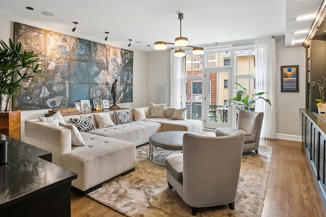 living room featuring wood finished floors and baseboards
