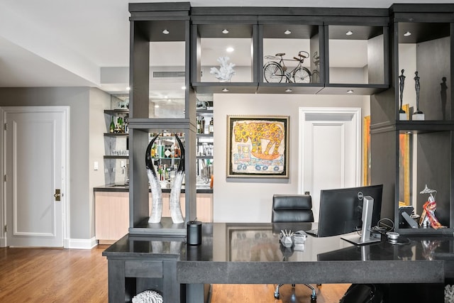 home office with wood finished floors and baseboards