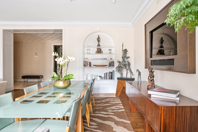 dining room featuring wood finished floors and crown molding