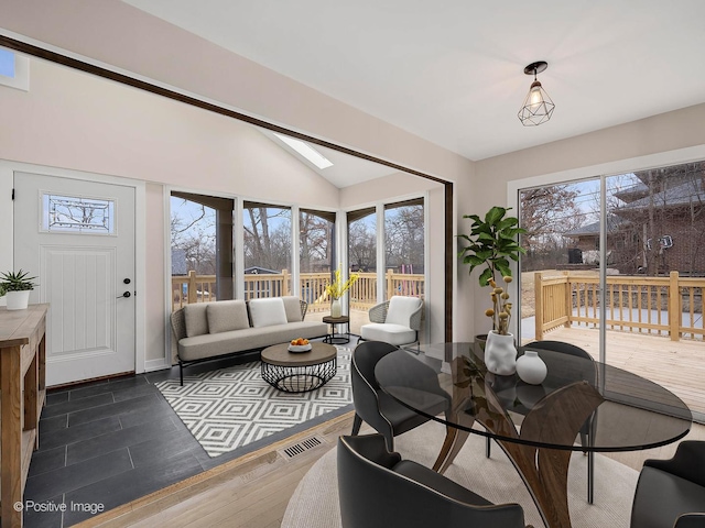 interior space featuring visible vents, lofted ceiling, and dark wood finished floors