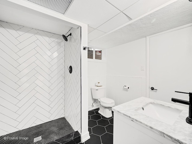 bathroom with vanity, visible vents, a shower stall, toilet, and tile patterned flooring