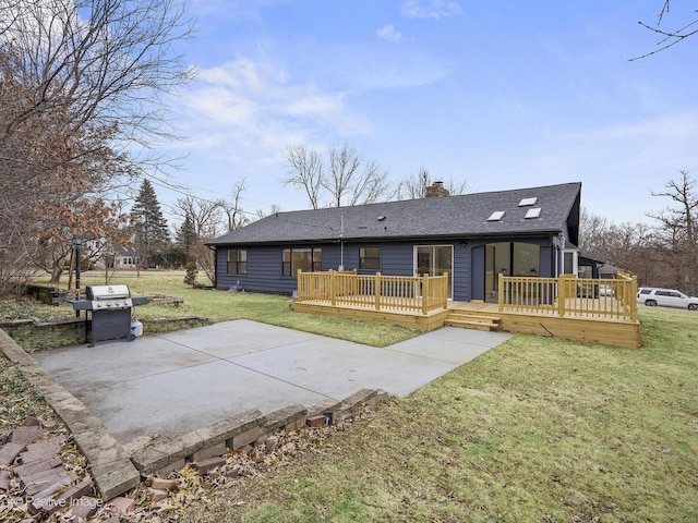 view of front of property featuring a wooden deck, a chimney, a patio, and a front yard