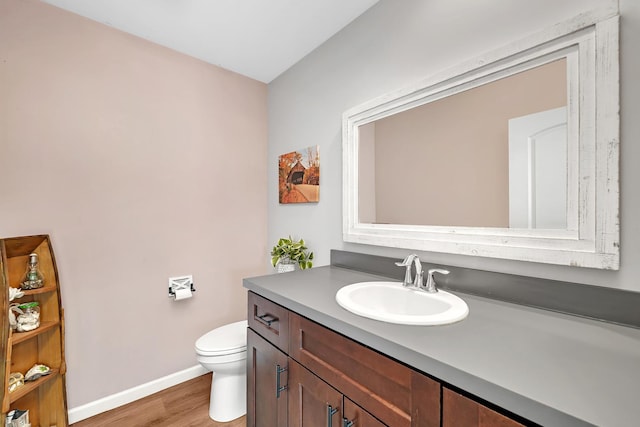 851 Western Ave, Braidwood, IL 60408 - half bath featuring vanity, toilet, wood finished floors, and baseboards