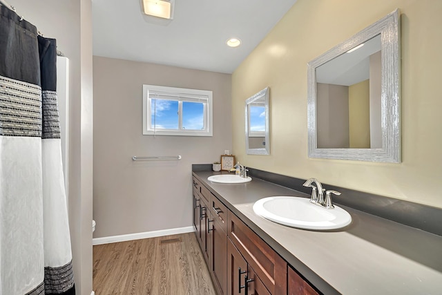 851 Western Ave, Braidwood, IL 60408 - full bath featuring a sink, baseboards, wood finished floors, and double vanity