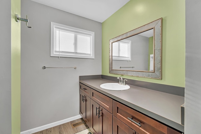 851 Western Ave, Braidwood, IL 60408 - bathroom featuring vanity, wood finished floors, and baseboards