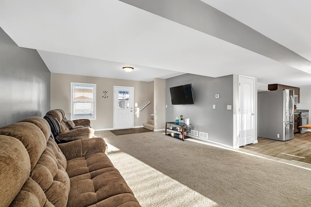 851 Western Ave, Braidwood, IL 60408 - living room with stairway, visible vents, baseboards, vaulted ceiling, and light colored carpet