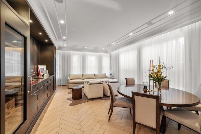 dining room featuring light parquet flooring and ornamental molding