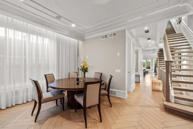 dining area with ornamental molding and light parquet floors