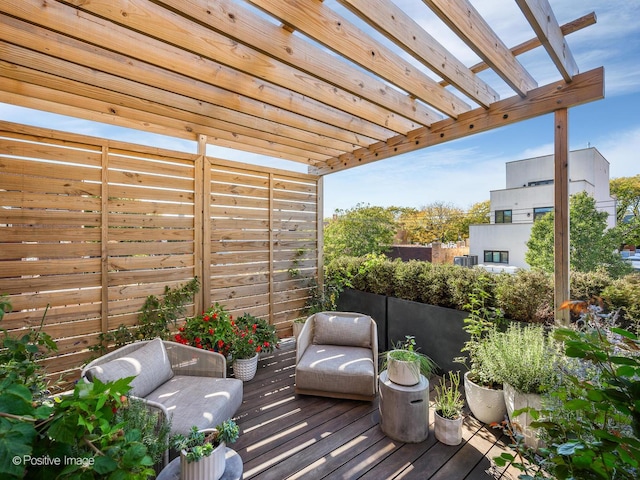 wooden deck with a pergola and an outdoor hangout area