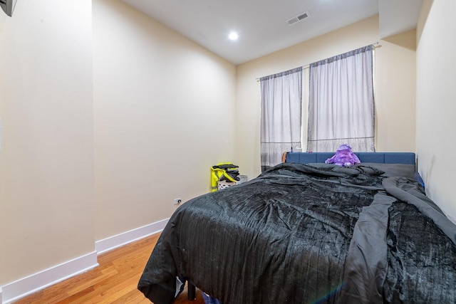 bedroom with hardwood / wood-style flooring