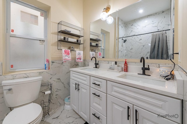 bathroom with toilet, tile walls, and vanity
