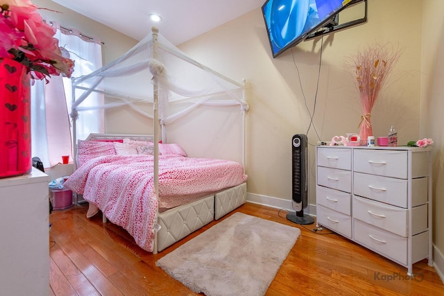 bedroom with wood-type flooring