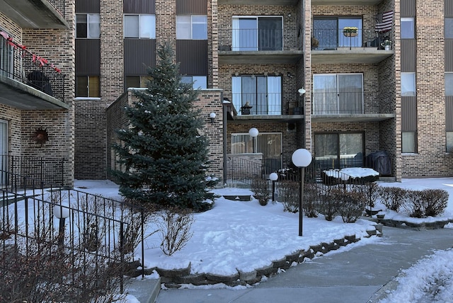 snow covered building with fence