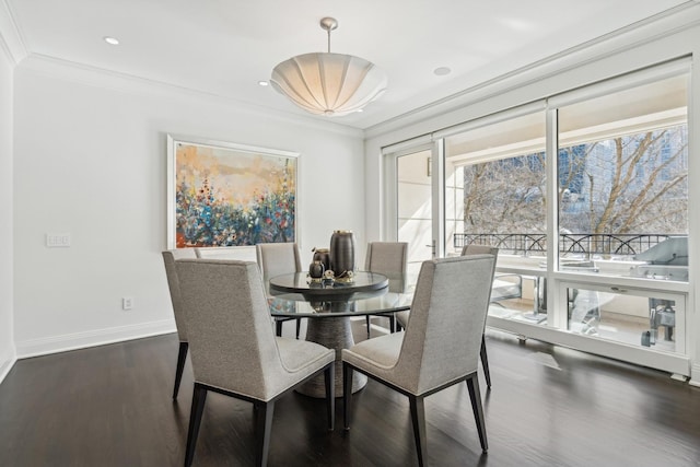 dining area featuring ornamental molding, dark wood-type flooring, recessed lighting, and baseboards