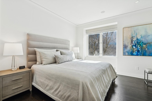 bedroom with baseboards and dark wood finished floors