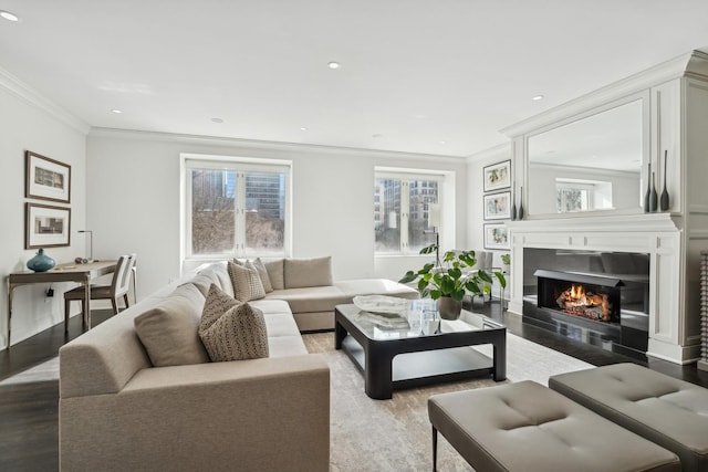 living area with recessed lighting, a fireplace, crown molding, and wood finished floors