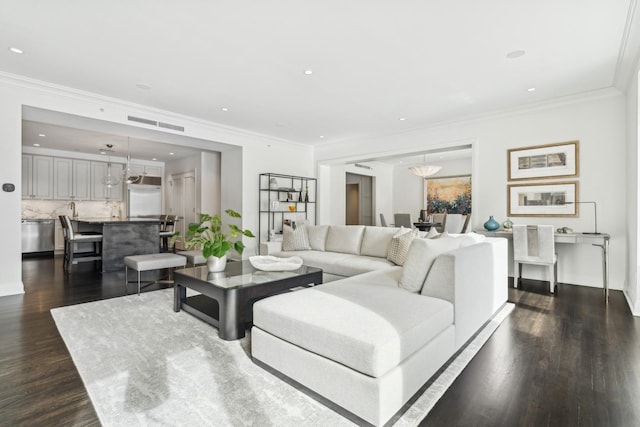 living area with visible vents, ornamental molding, dark wood-style flooring, and recessed lighting