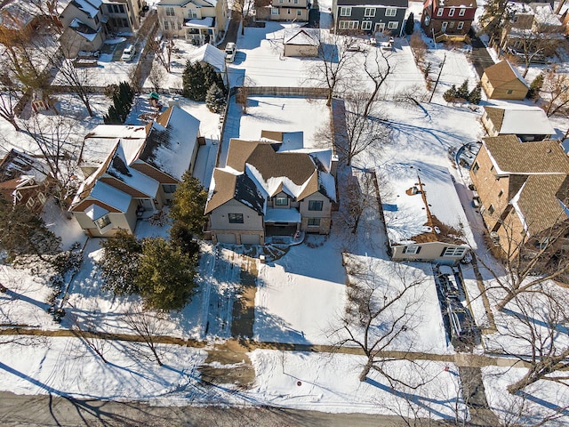 snowy aerial view with a residential view