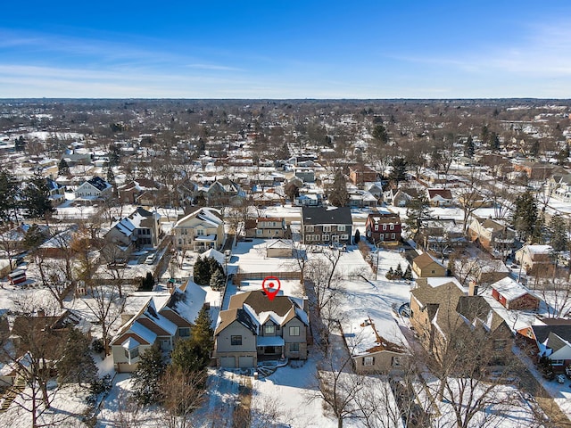 snowy aerial view with a residential view