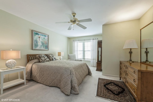 bedroom with light carpet and ceiling fan