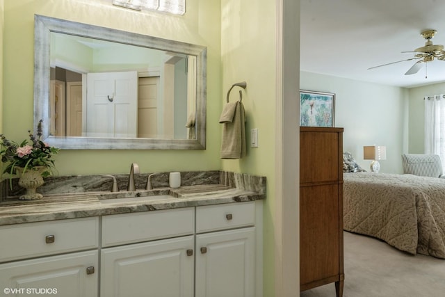 bathroom featuring vanity, ensuite bath, and a ceiling fan