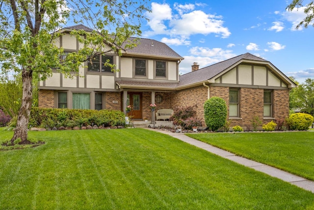 1185 Surrey Ln, Itasca, IL 60143 - english style home with stucco siding, a front yard, brick siding, and a porch