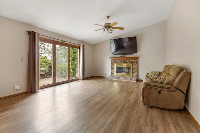 1185 Surrey Ln, Itasca, IL 60143 - living area with wood finished floors, baseboards, ceiling fan, a fireplace, and lofted ceiling