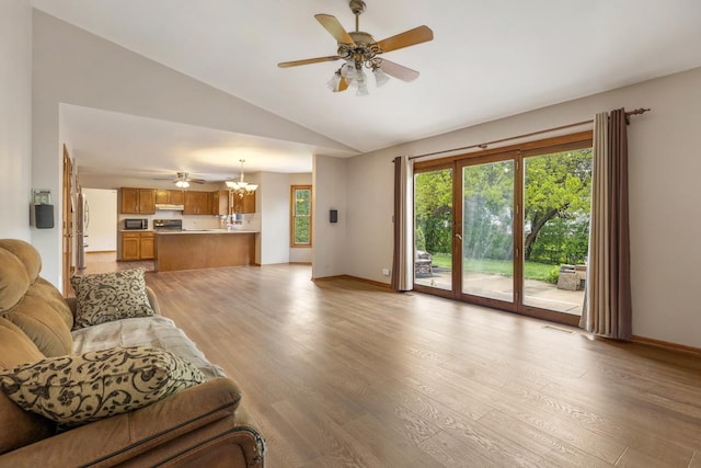 1185 Surrey Ln, Itasca, IL 60143 - living room with a ceiling fan, vaulted ceiling, light wood-type flooring, baseboards, and a chandelier