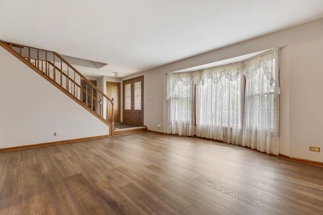 1185 Surrey Ln, Itasca, IL 60143 - unfurnished living room with wood finished floors, healthy amount of natural light, stairway, and baseboards