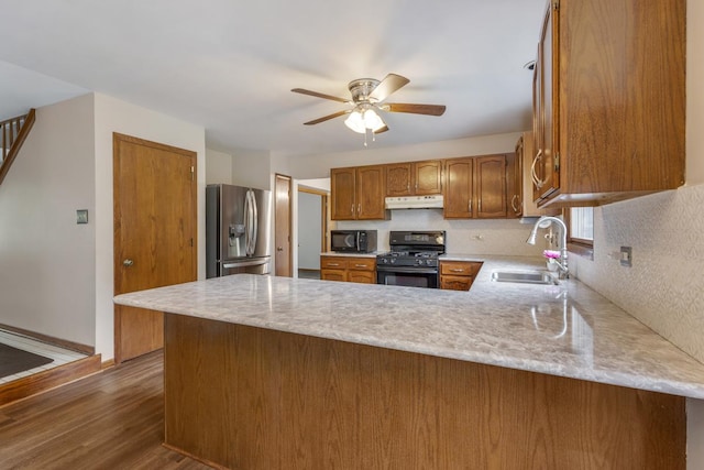 1185 Surrey Ln, Itasca, IL 60143 - kitchen with black appliances, a sink, under cabinet range hood, a peninsula, and dark wood-style flooring