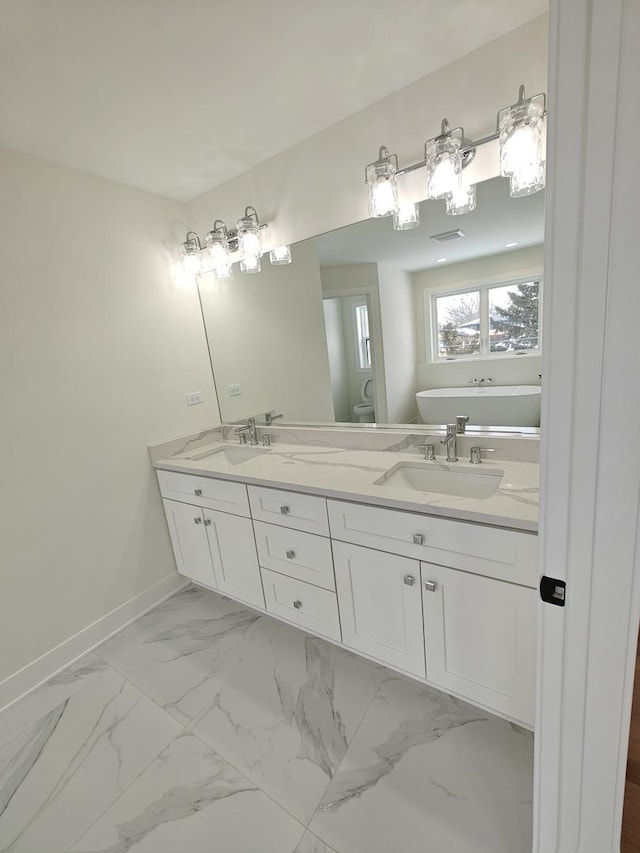 bathroom with vanity and a tub to relax in