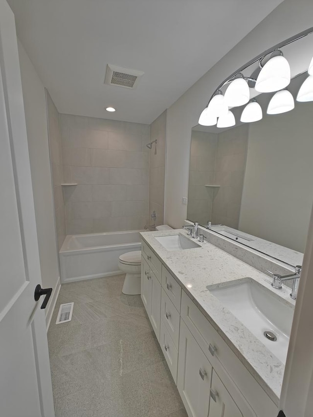 full bathroom with tiled shower / bath combo, vanity, and toilet