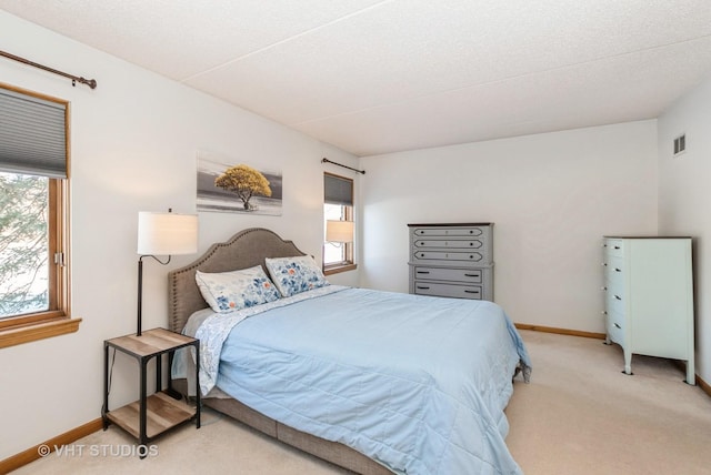 bedroom featuring carpet floors, visible vents, and baseboards