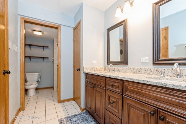 full bath featuring double vanity, tile patterned flooring, a sink, and toilet