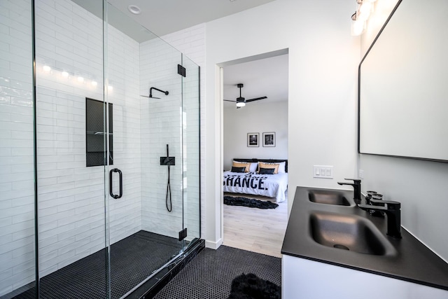 ensuite bathroom featuring ensuite bathroom, a sink, a ceiling fan, double vanity, and a stall shower