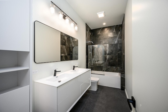 full bath featuring double vanity, shower / tub combination, a sink, and toilet