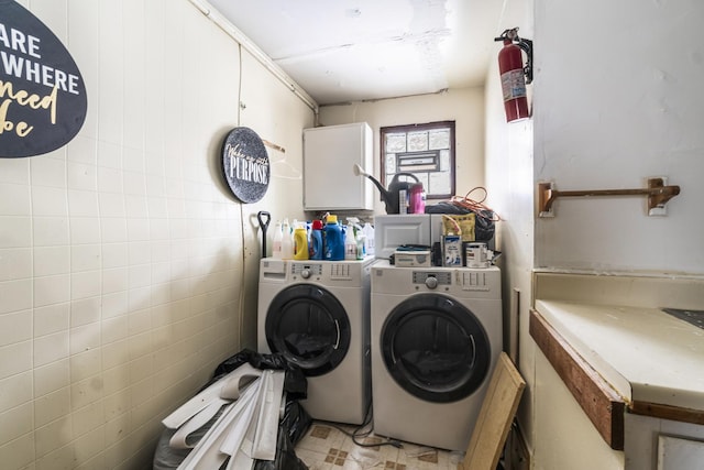 laundry room featuring cabinets and washer and dryer