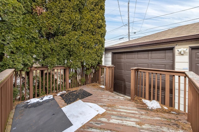 wooden deck featuring a garage