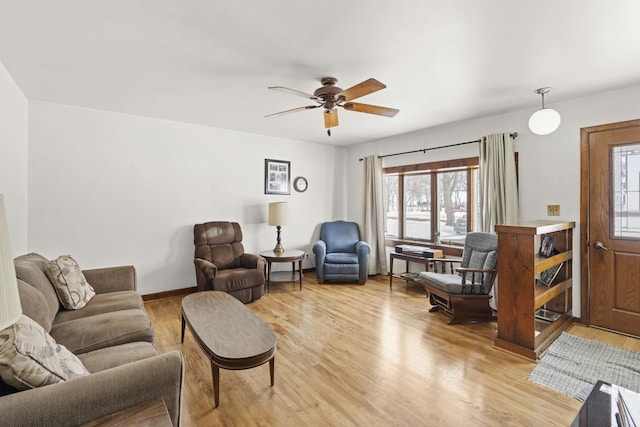 living room featuring ceiling fan and light hardwood / wood-style flooring