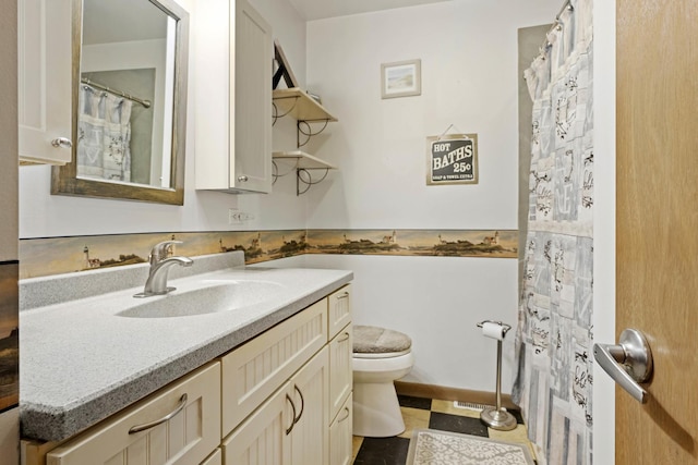 bathroom with toilet and vanity