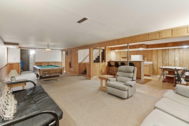 living room featuring billiards, light colored carpet, and wooden walls