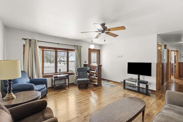 living room with ceiling fan and wood-type flooring