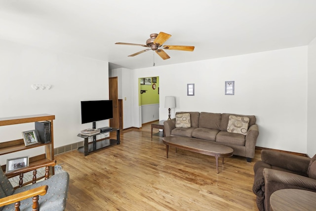 living room with hardwood / wood-style flooring and ceiling fan