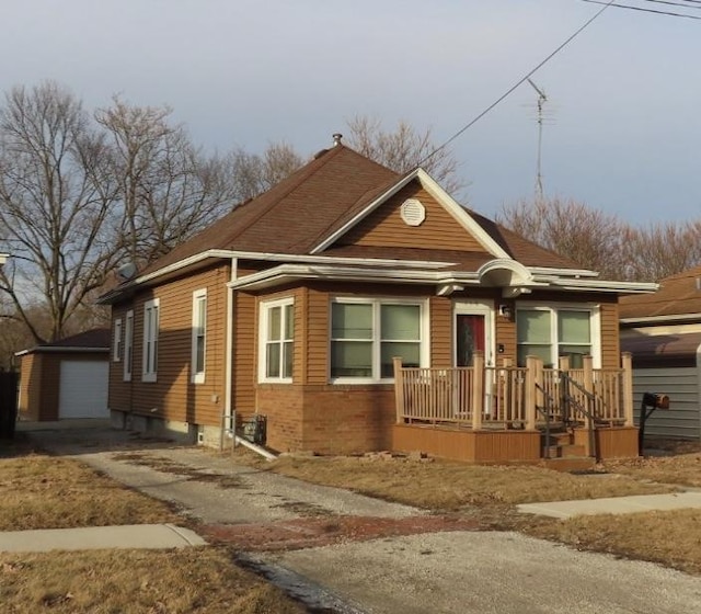 view of front of home featuring a garage and an outdoor structure