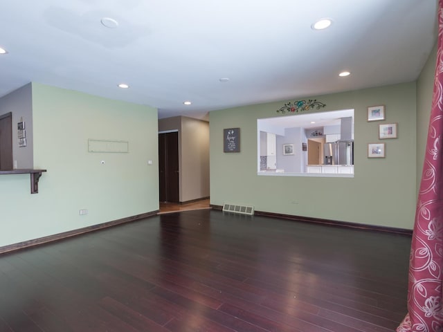 unfurnished room featuring dark hardwood / wood-style flooring