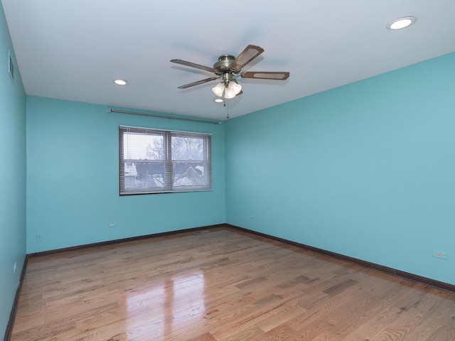 spare room with light hardwood / wood-style floors and ceiling fan