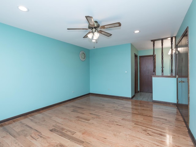 empty room with ceiling fan and light wood-type flooring